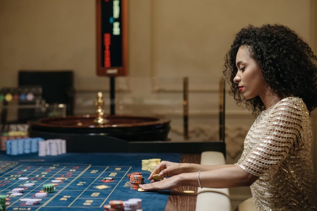Woman playing roulette at casino